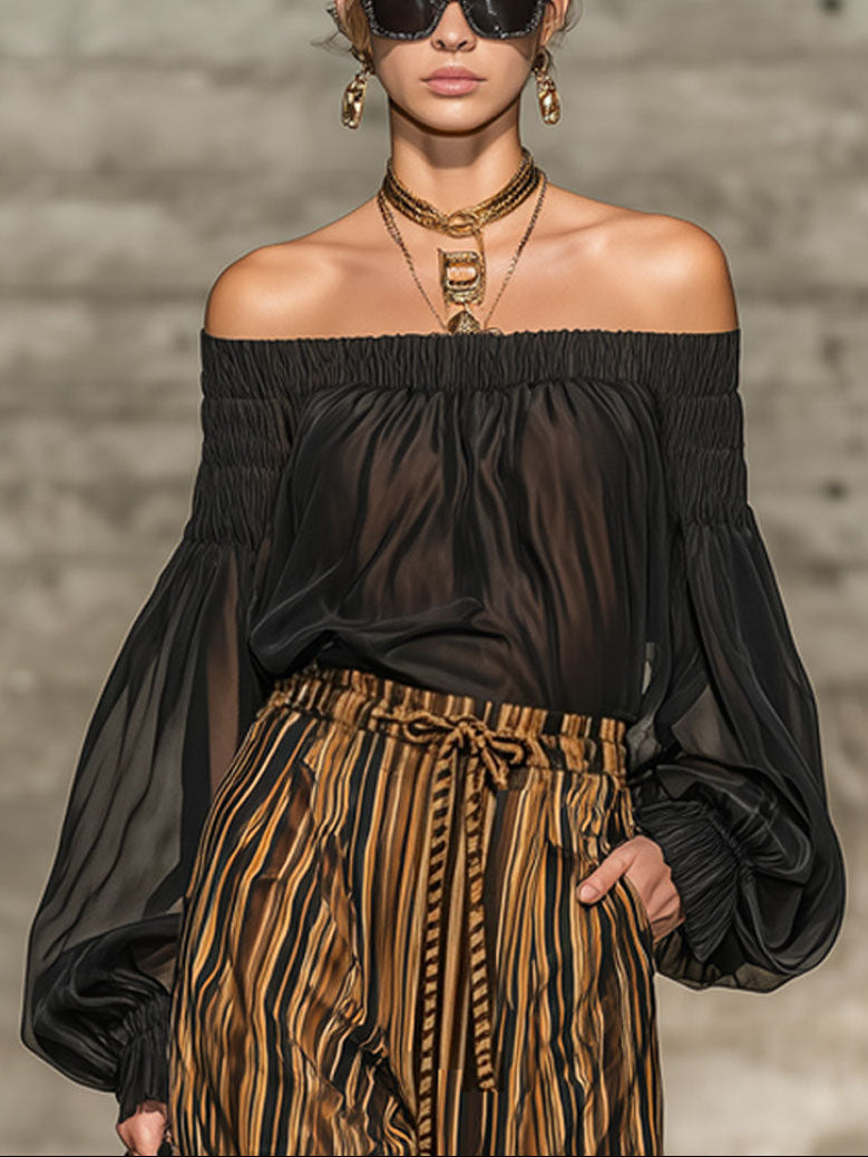 Elegant black off-the-shoulder top and striped wide-leg trousers set